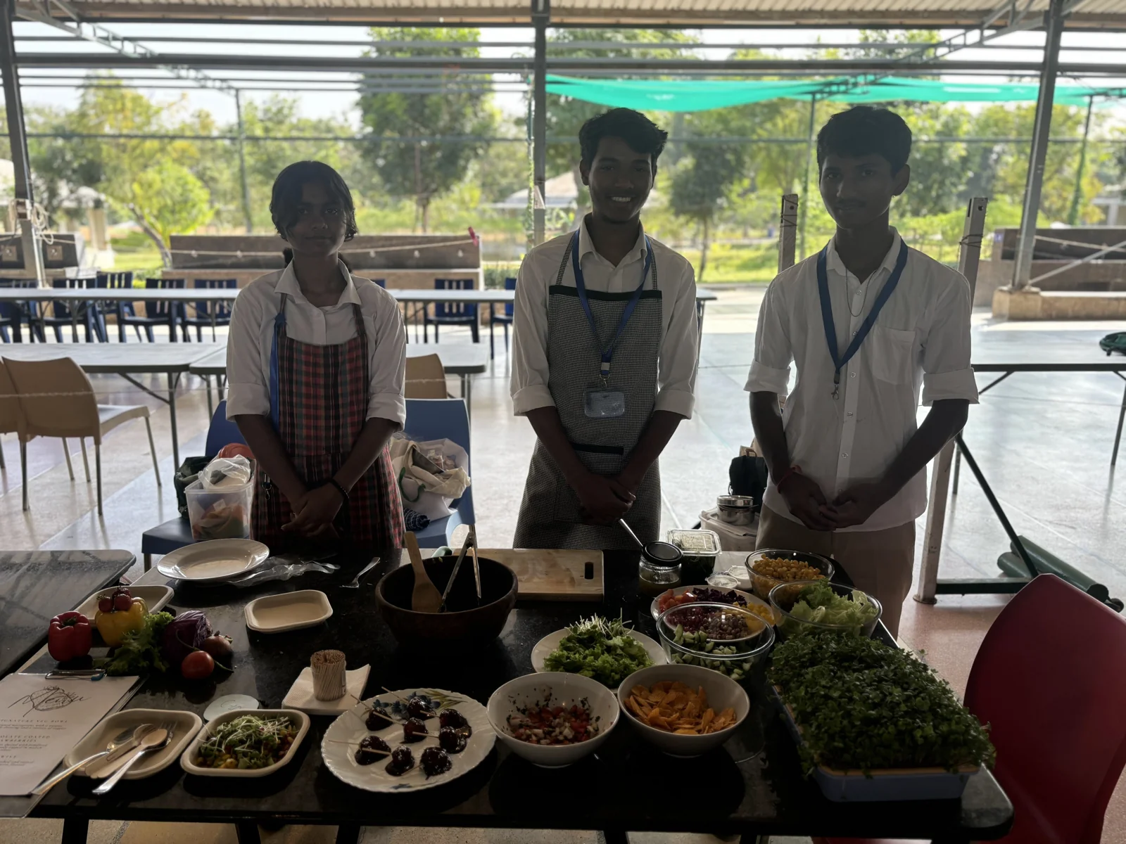 Students presenting salads and fresh food they prepared
